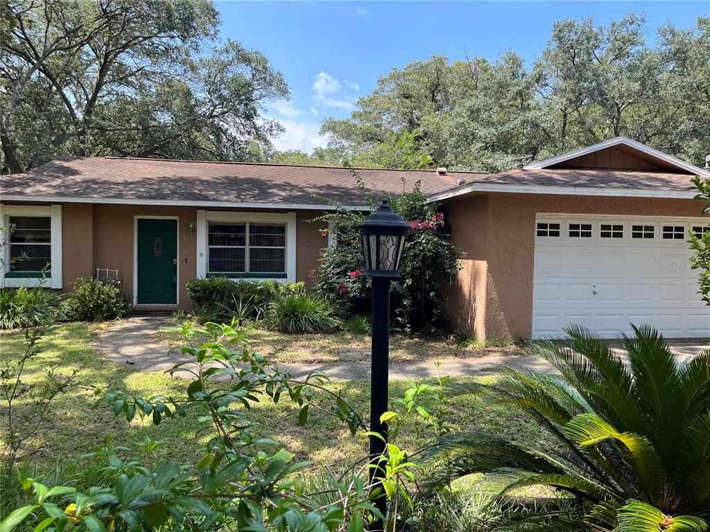 1920 Sydney Road Valrico, FL 33594 - Photo 1 of 1 a front view of a house with garden