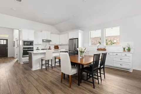 a view of a dining room with furniture and wooden floor