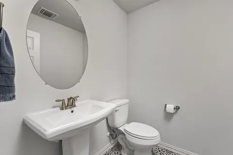 a bathroom with a sink a mirror and a toilet