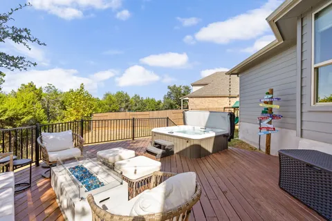 a roof deck with a dining table and chairs with wooden floor