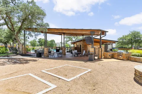 a view of a patio with a table and chairs under an umbrella