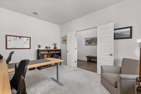 a view of a livingroom with workspace and a couch