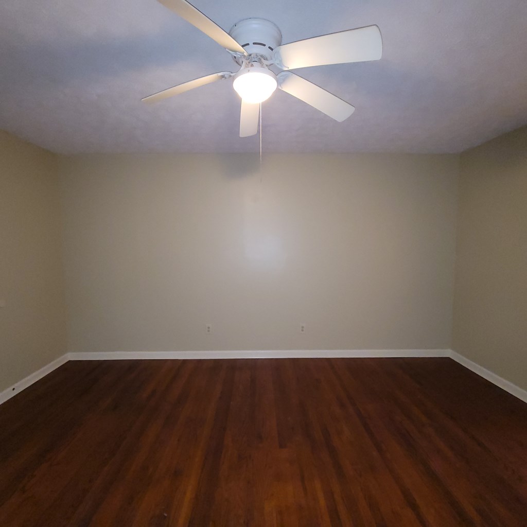 1547 38th Street Columbus, GA 31904 - Photo 14 of 24 an empty room with wooden floor and fan