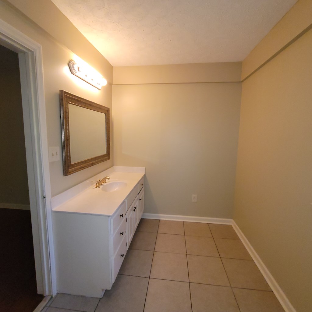 1547 38th Street Columbus, GA 31904 - Photo 16 of 24 a bathroom with a sink a toilet and mirror