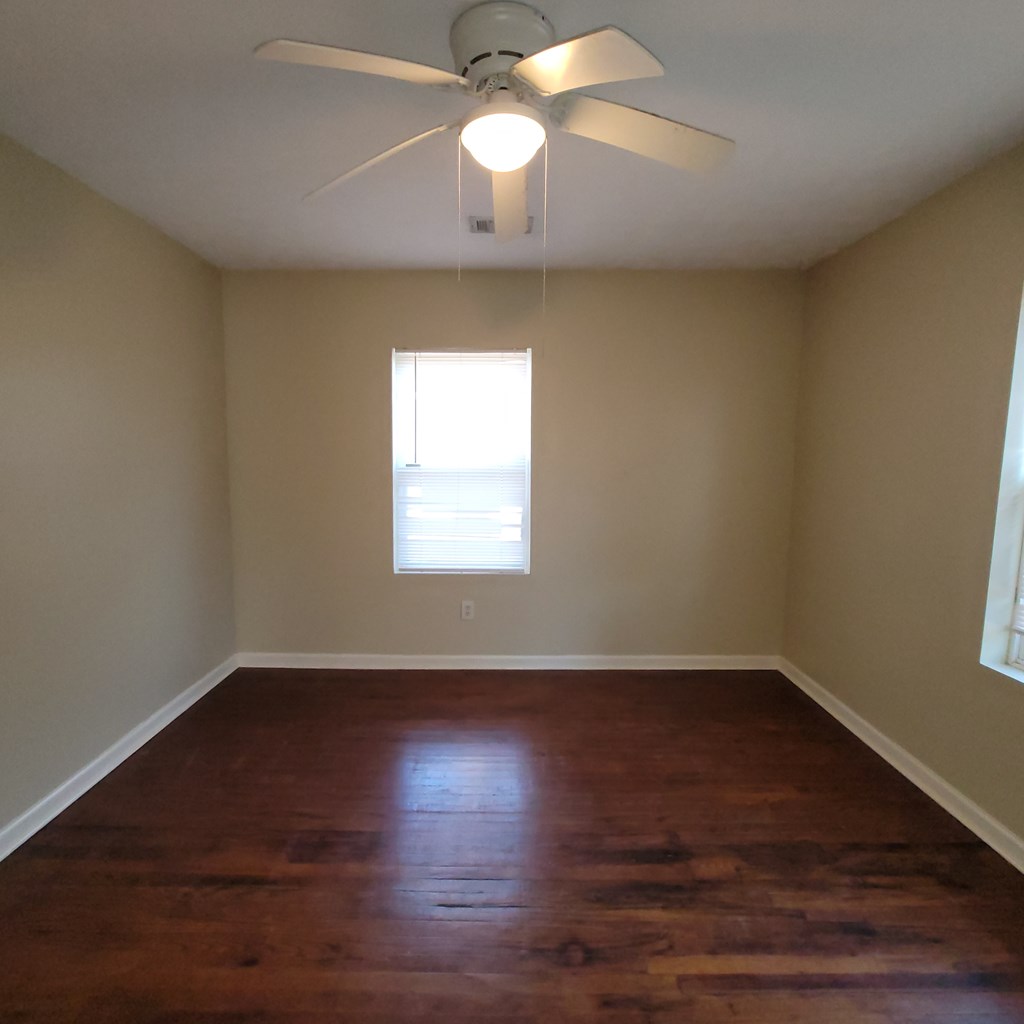 1547 38th Street Columbus, GA 31904 - Photo 21 of 24 a view of an empty room with wooden floor and a window