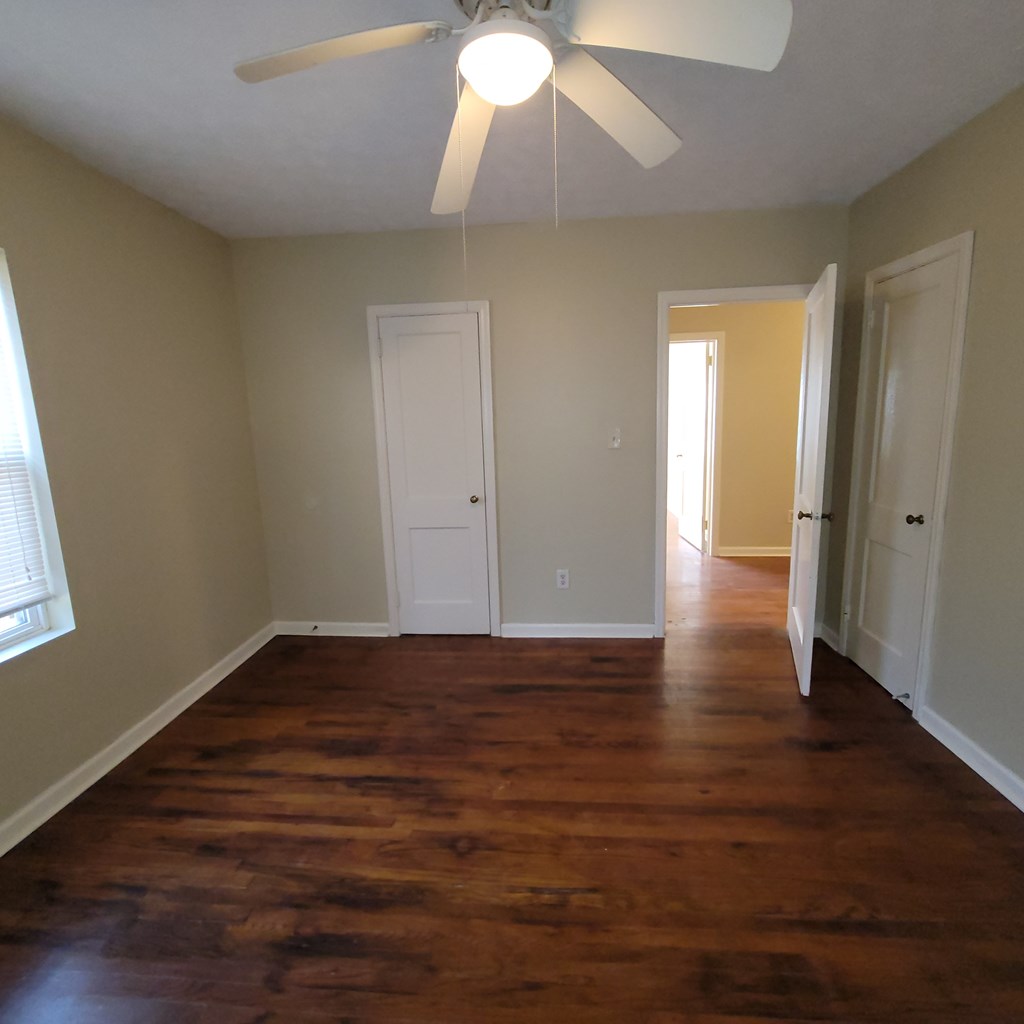 1547 38th Street Columbus, GA 31904 - Photo 22 of 24 a view of an empty room with wooden floor and a window