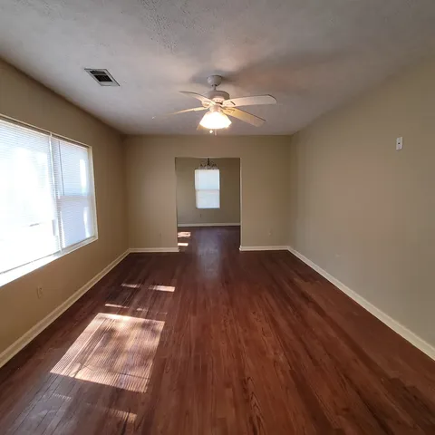 a view of workspace with wooden floor and window