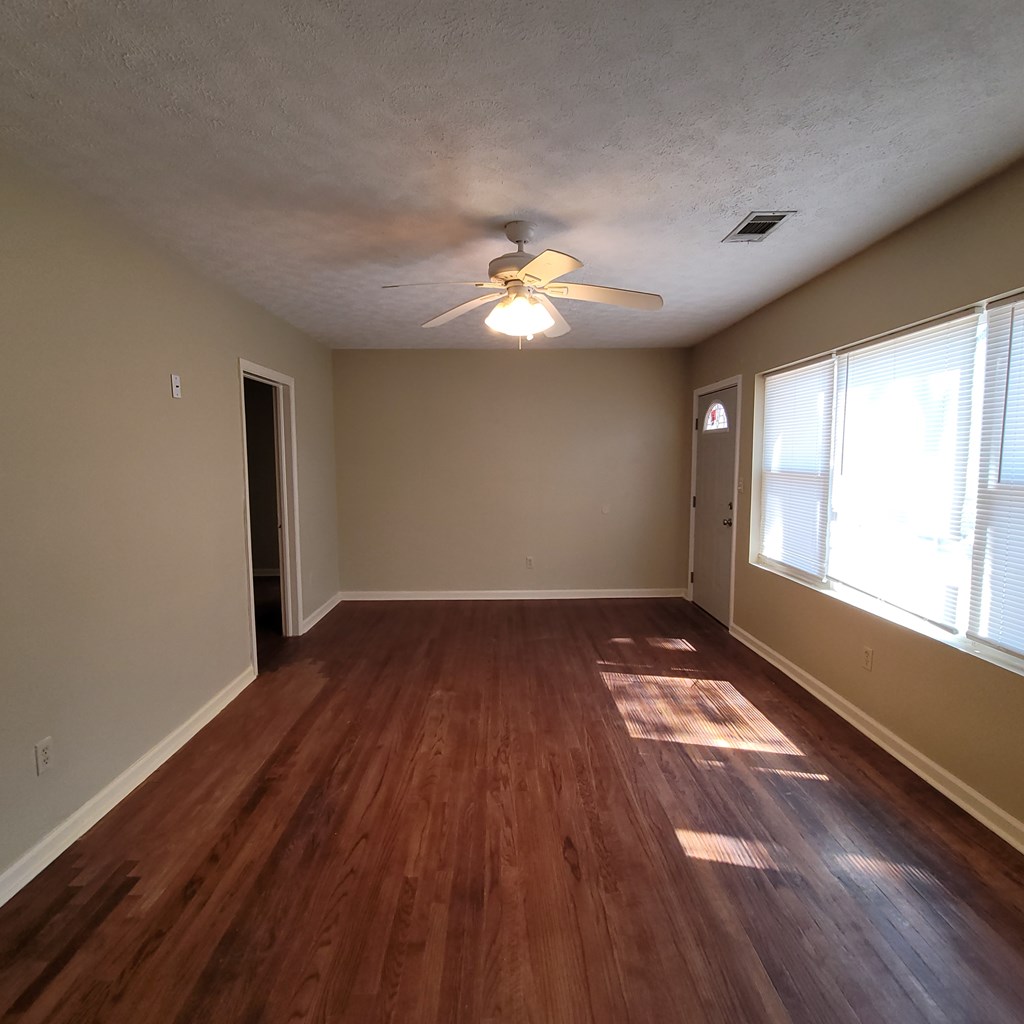 1547 38th Street Columbus, GA 31904 - Photo 6 of 24 an empty room with wooden floor and windows