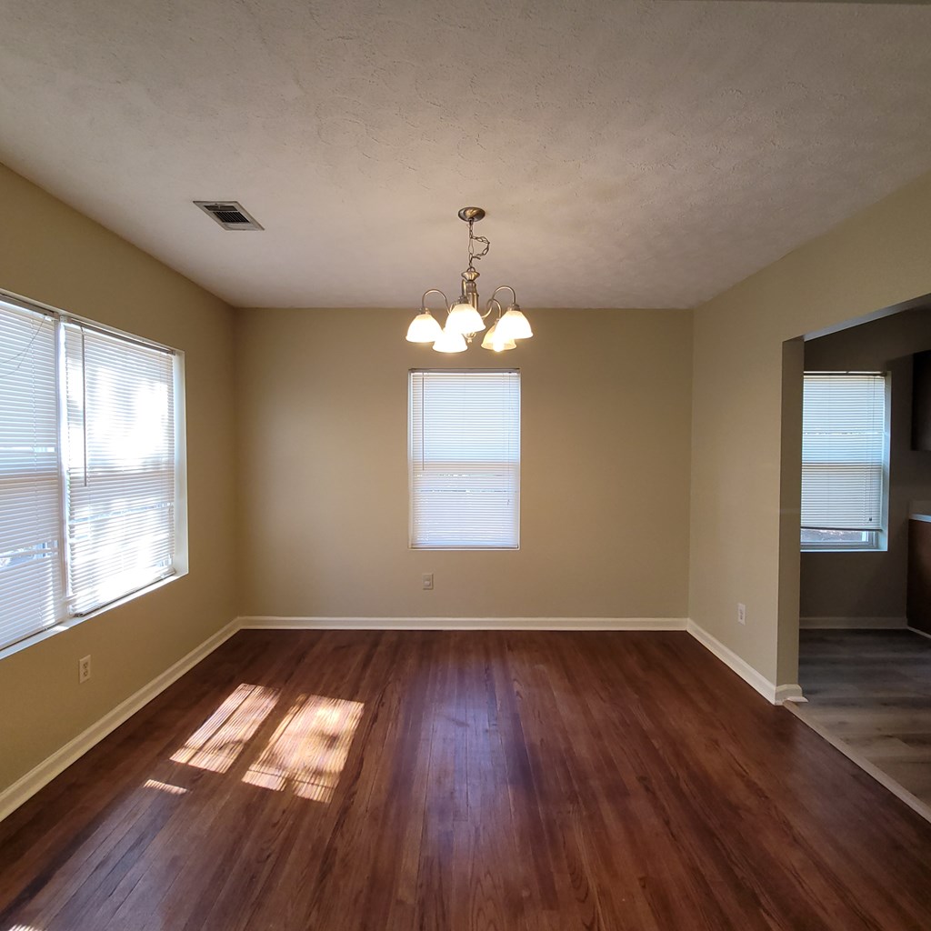 1547 38th Street Columbus, GA 31904 - Photo 7 of 24 a view of an empty room with wooden floor and a window