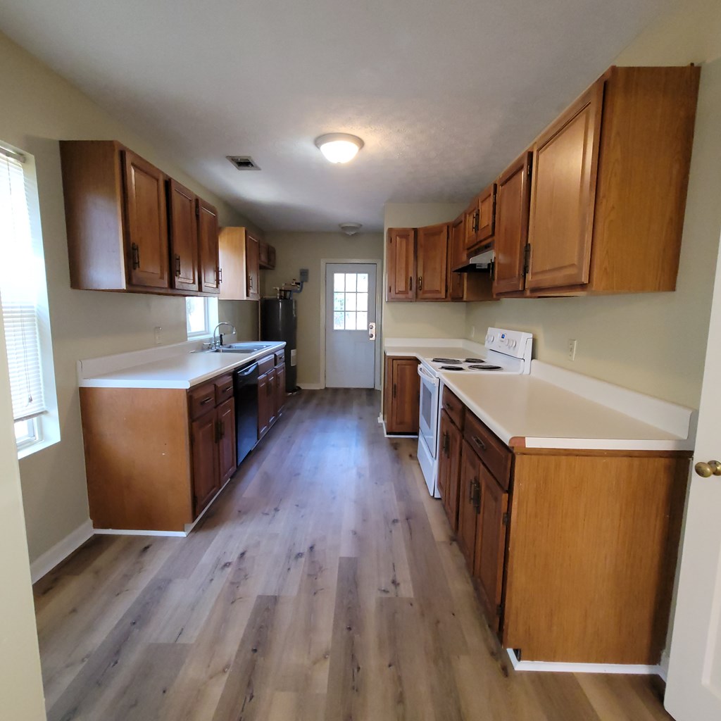 1547 38th Street Columbus, GA 31904 - Photo 9 of 24 a kitchen with a sink a counter top space stainless steel appliances and cabinets