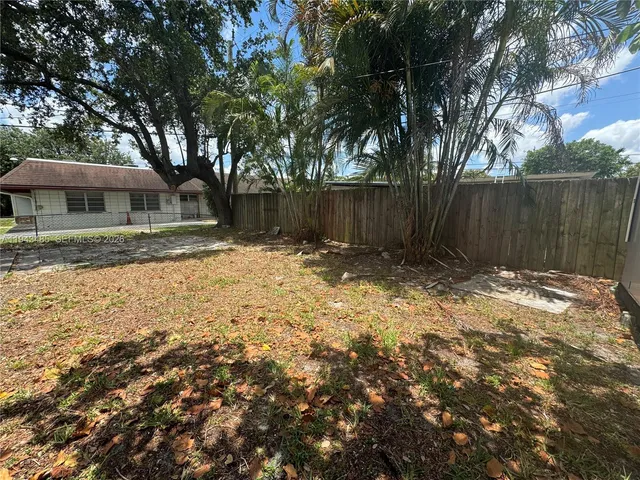 a view of a yard with a large tree