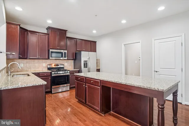 a kitchen with granite countertop lots of counter top space and living room