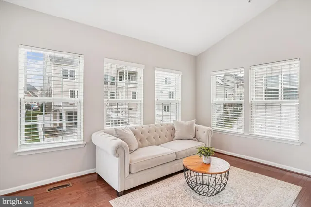 a view of a kitchen from the hallway with a bathroom