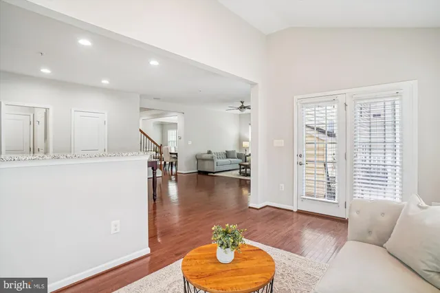 a view of a hallway with wooden floor and door