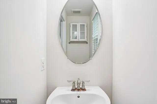 a spacious bedroom with a bed a window and dresser