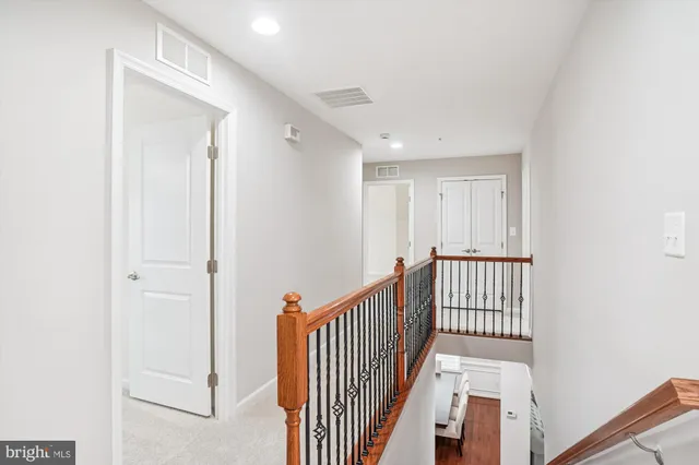 a bedroom with a bed a table and a chandelier