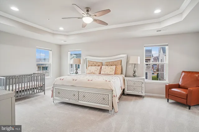 an empty room with a window and ceiling fan