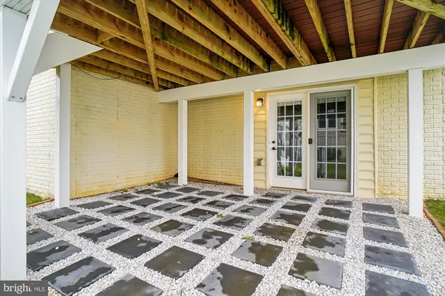 a front view of a house with yard and trees