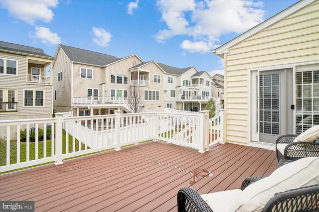 a front view of a house with a garden and lake view