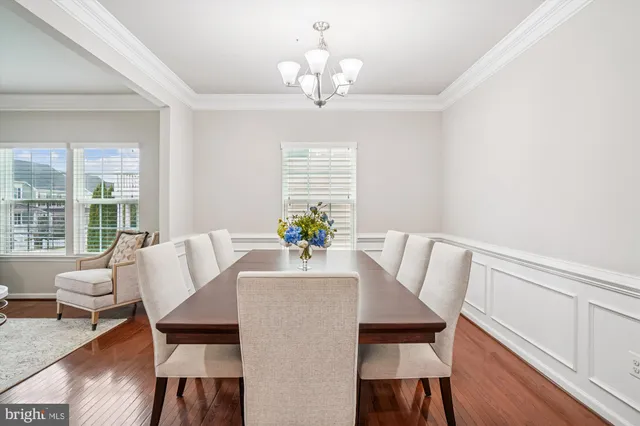 a kitchen with stainless steel appliances granite countertop a kitchen island a stove a refrigerator a sink and a center island