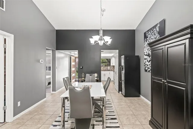 a dining room with furniture a chandelier and wooden floor