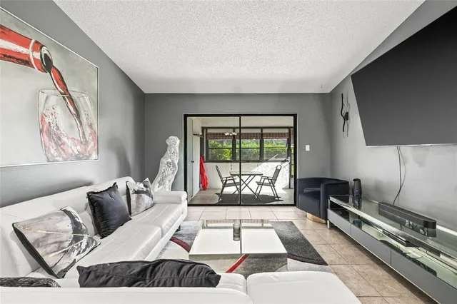 a living room with furniture and a floor to ceiling window