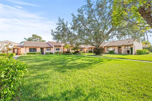 a front view of house with yard and green space