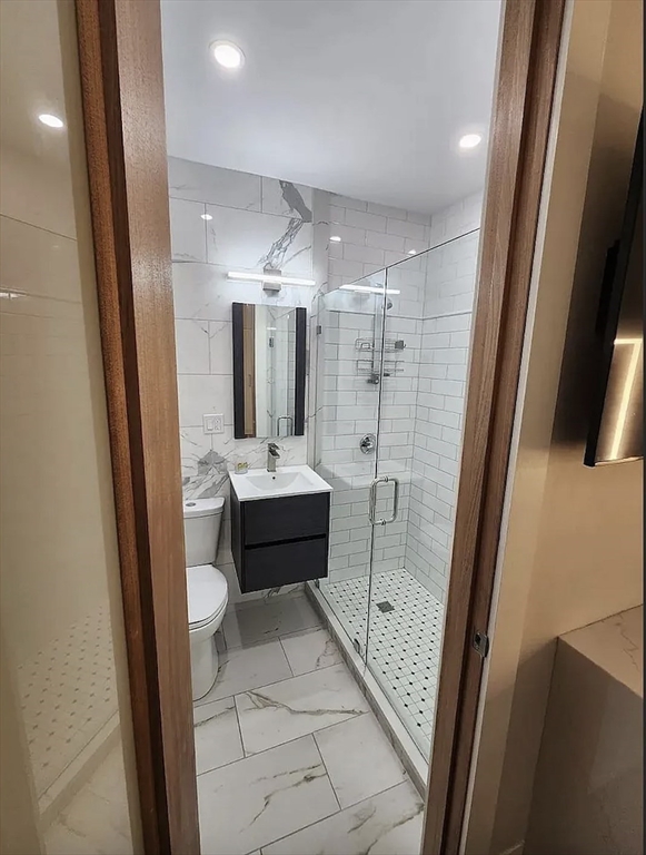 362 Commonwealth Avenue, Unit 1B Boston, MA 02115 - Photo 2 of 5 a bathroom with a double vanity sink toilet and shower