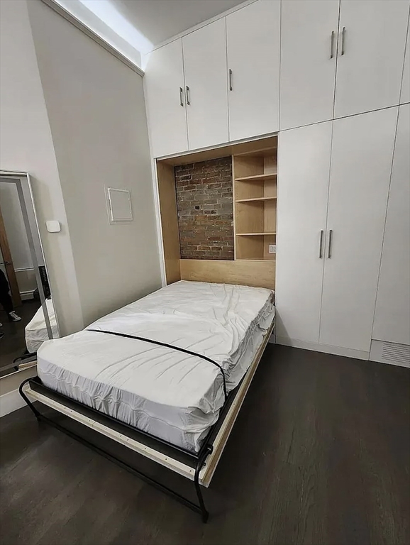 362 Commonwealth Avenue, Unit 1B Boston, MA 02115 - Photo 4 of 5 a large bed sitting in a room next to a cabinet