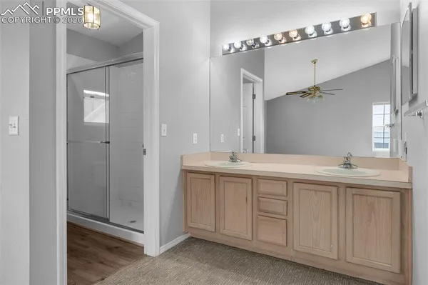 a spacious bathroom with a double vanity sink and mirror