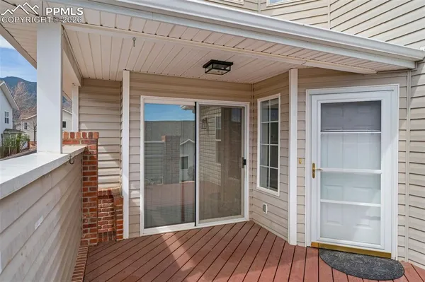 a view of a porch with wooden floor and a window