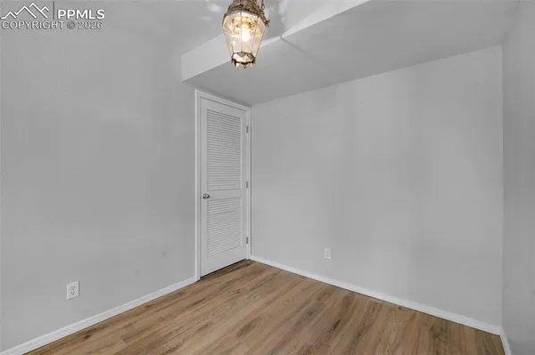 a view of a room with wooden floor