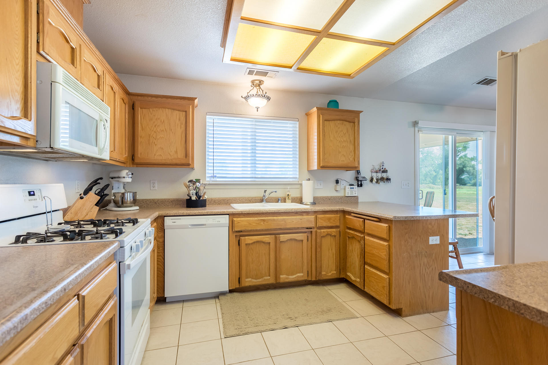 4301 Panorama Point Road Cottonwood, CA 96022 - Photo 5 of 20 a kitchen with a stove a sink and a refrigerator
