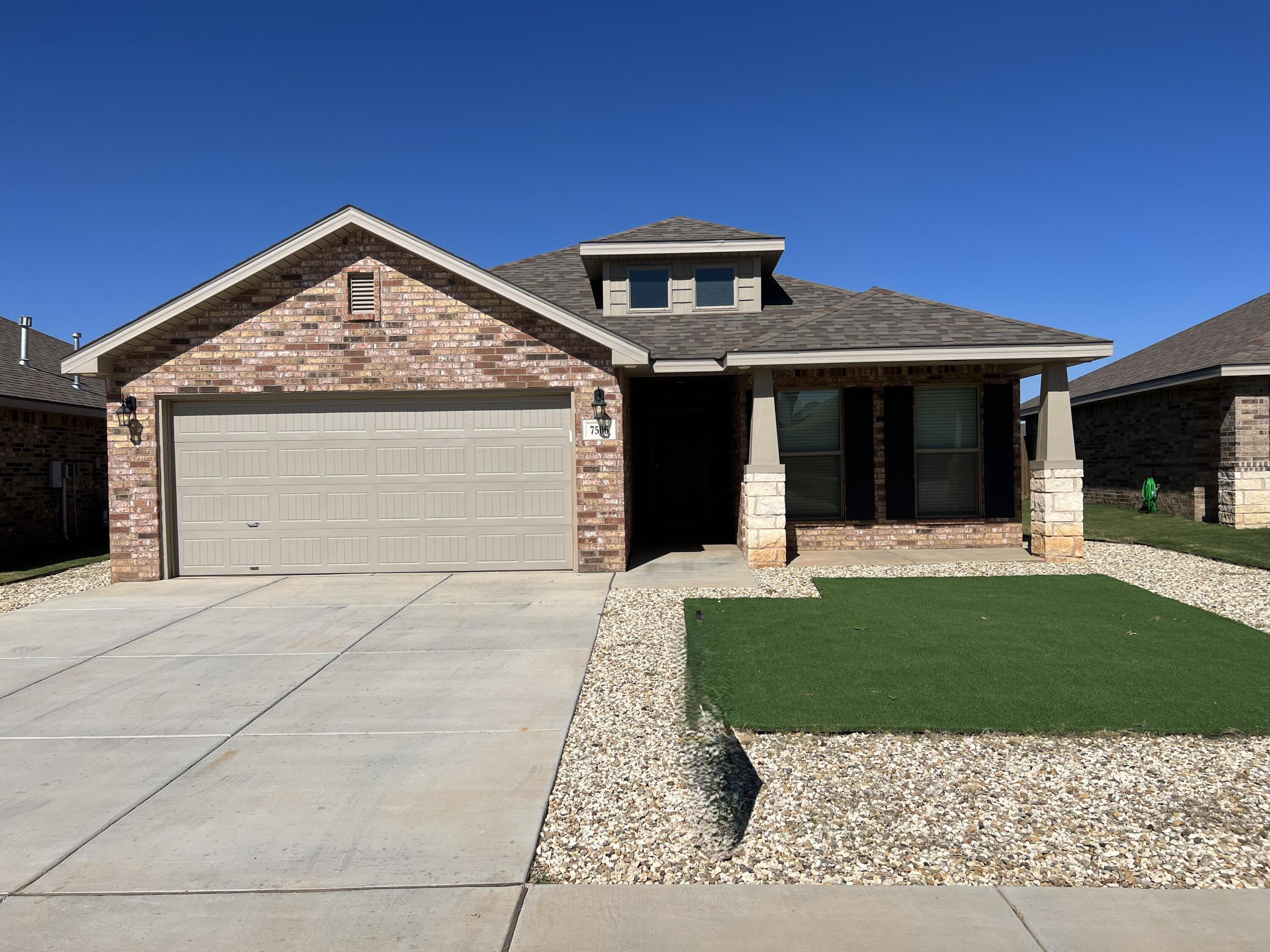 7506 100th Street Lubbock, TX 79424 - Photo 1 of 23 a front view of a house with a yard and garage