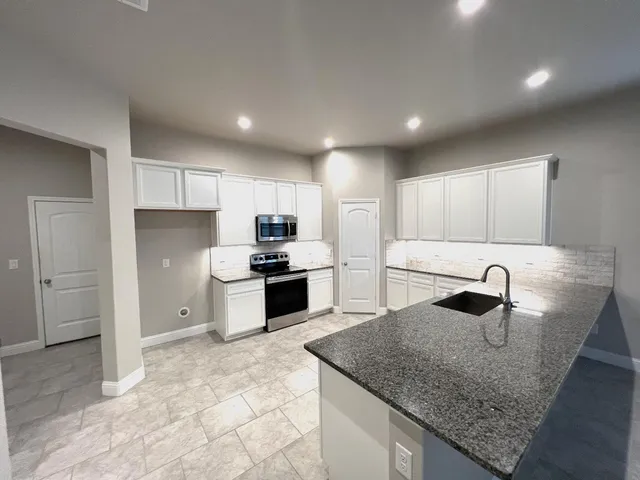 a view of hallway with a window and a bathroom