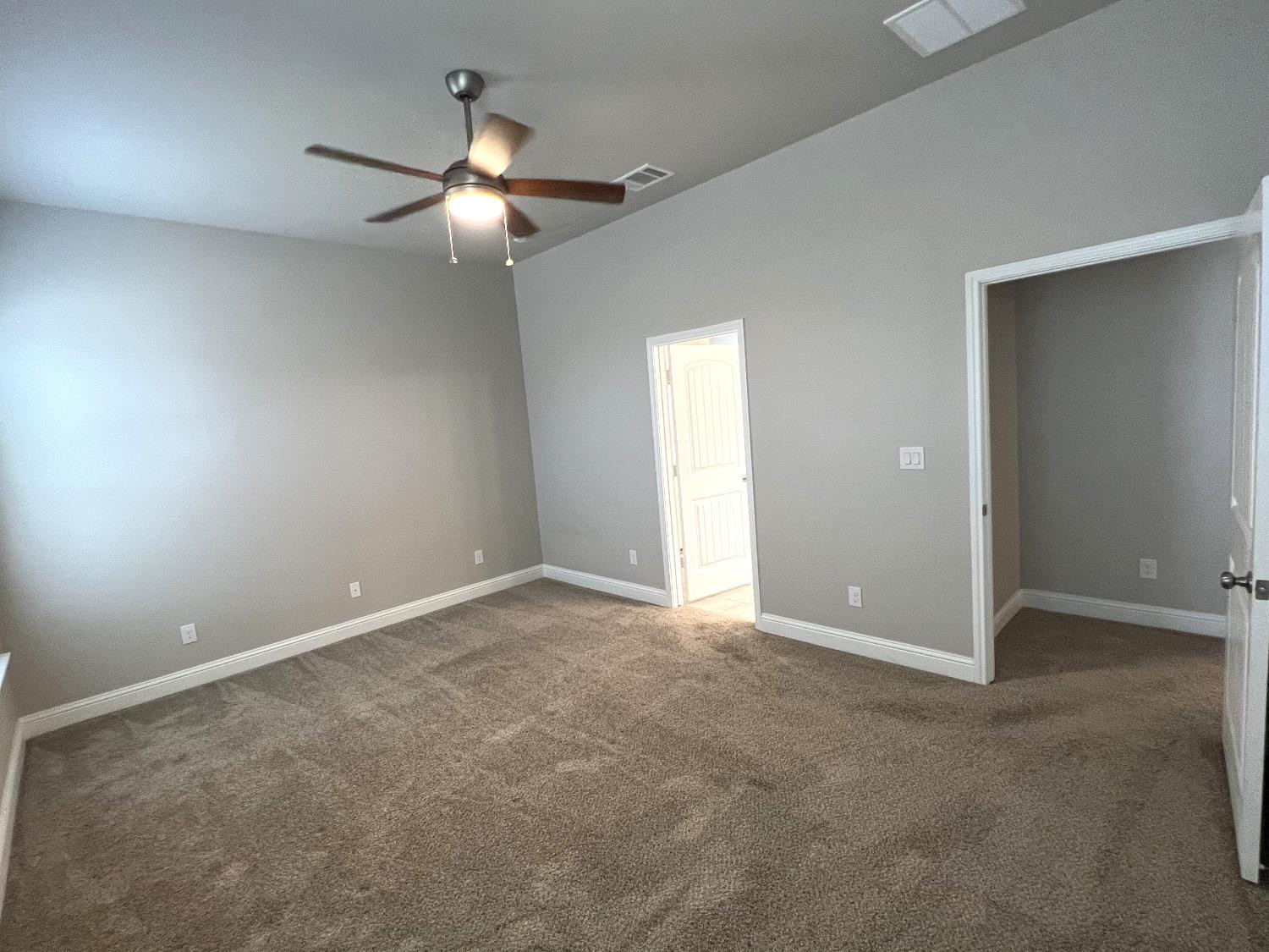 7506 100th Street Lubbock, TX 79424 - Photo 17 of 23 an empty room with a ceiling fan and window