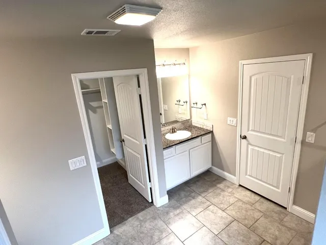 a view of a bathroom from a corridor