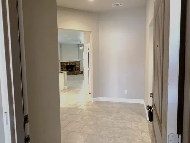 a view of a hallway with wooden shelves