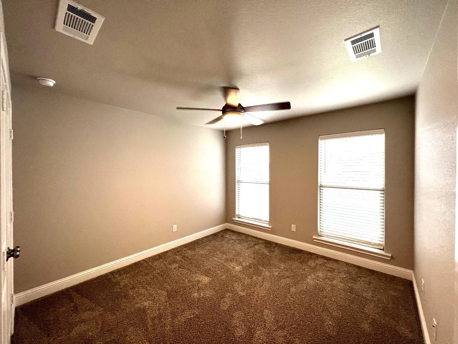 7506 100th Street Lubbock, TX 79424 - Photo 4 of 23 an empty room with windows