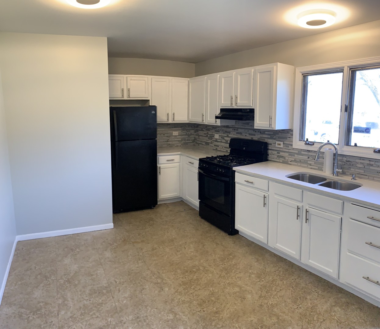 15339 9th Avenue Phoenix, IL 60426 - Photo 3 of 13 a kitchen with granite countertop white cabinets and stainless steel appliances