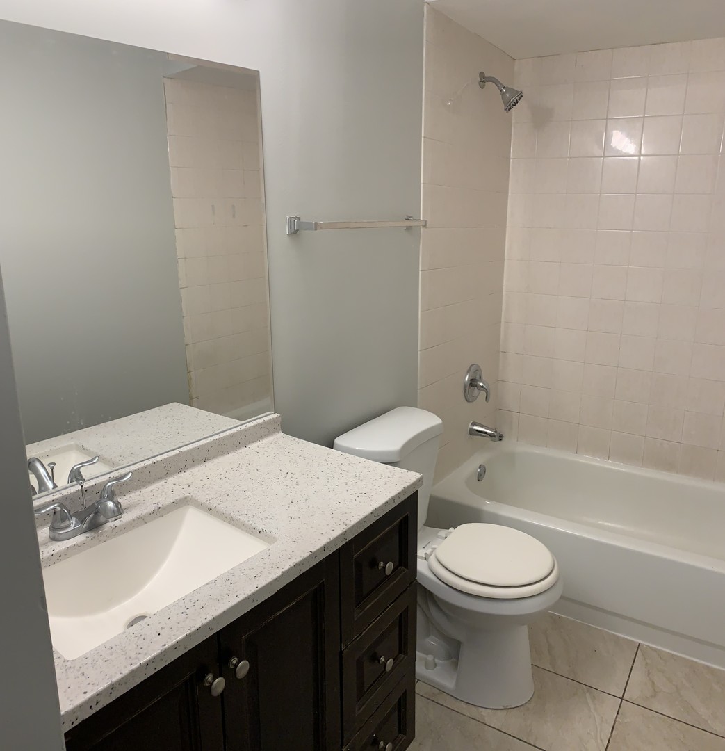 15339 9th Avenue Phoenix, IL 60426 - Photo 6 of 13 a bathroom with a sink a toilet and shower