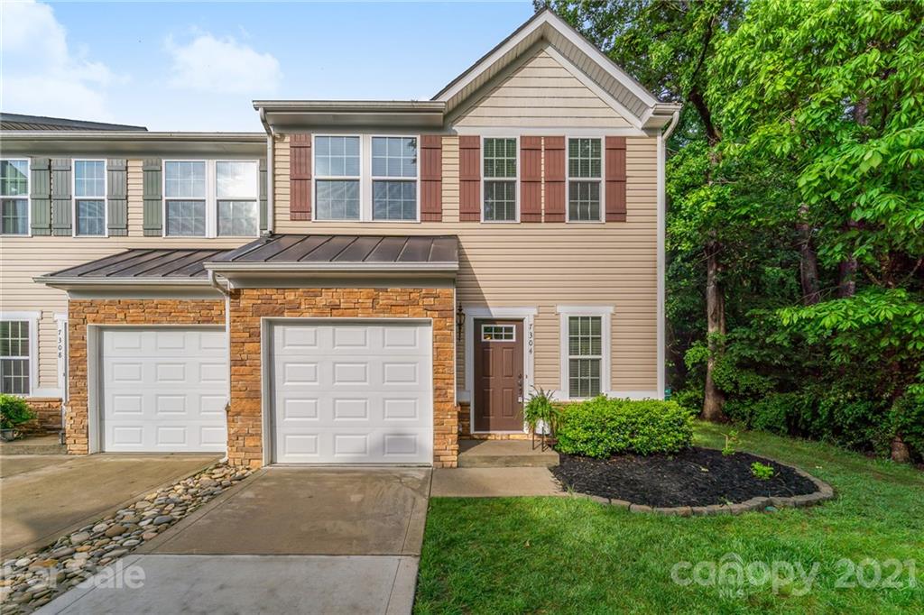 7304 Copper Beech Trace, Unit 13 Charlotte, NC 28273 - Photo 1 of 25 a front view of a house with garden