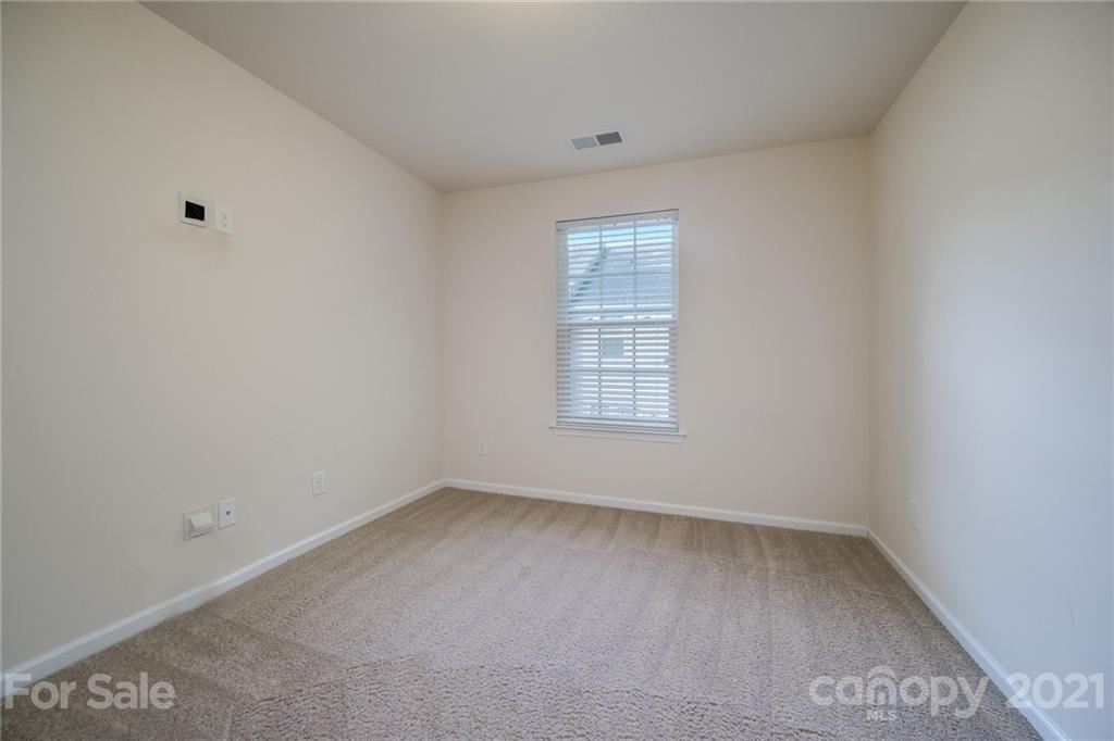 7304 Copper Beech Trace, Unit 13 Charlotte, NC 28273 - Photo 12 of 25 an empty room with a window