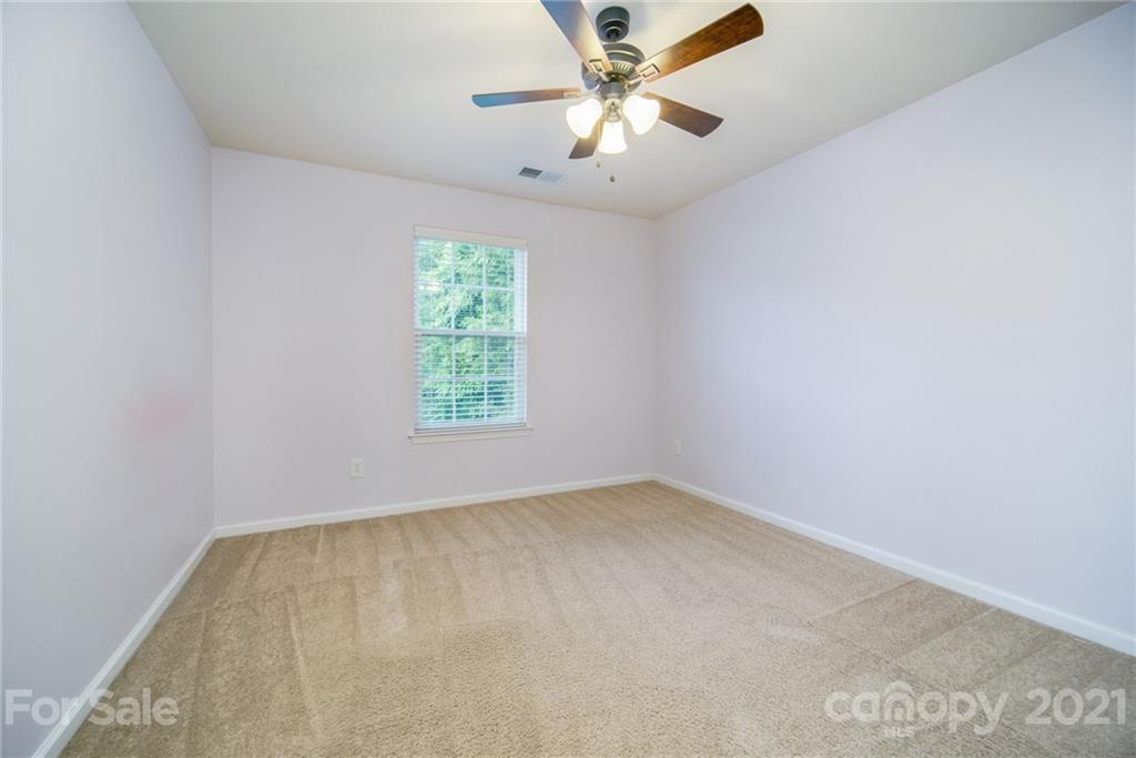 7304 Copper Beech Trace, Unit 13 Charlotte, NC 28273 - Photo 13 of 25 an empty room with a window and a fan