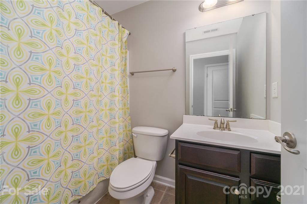 7304 Copper Beech Trace, Unit 13 Charlotte, NC 28273 - Photo 15 of 25 a bathroom with a toilet a sink and a mirror