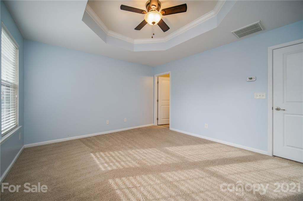 7304 Copper Beech Trace, Unit 13 Charlotte, NC 28273 - Photo 17 of 25 a view of an empty room with window and a ceiling fan