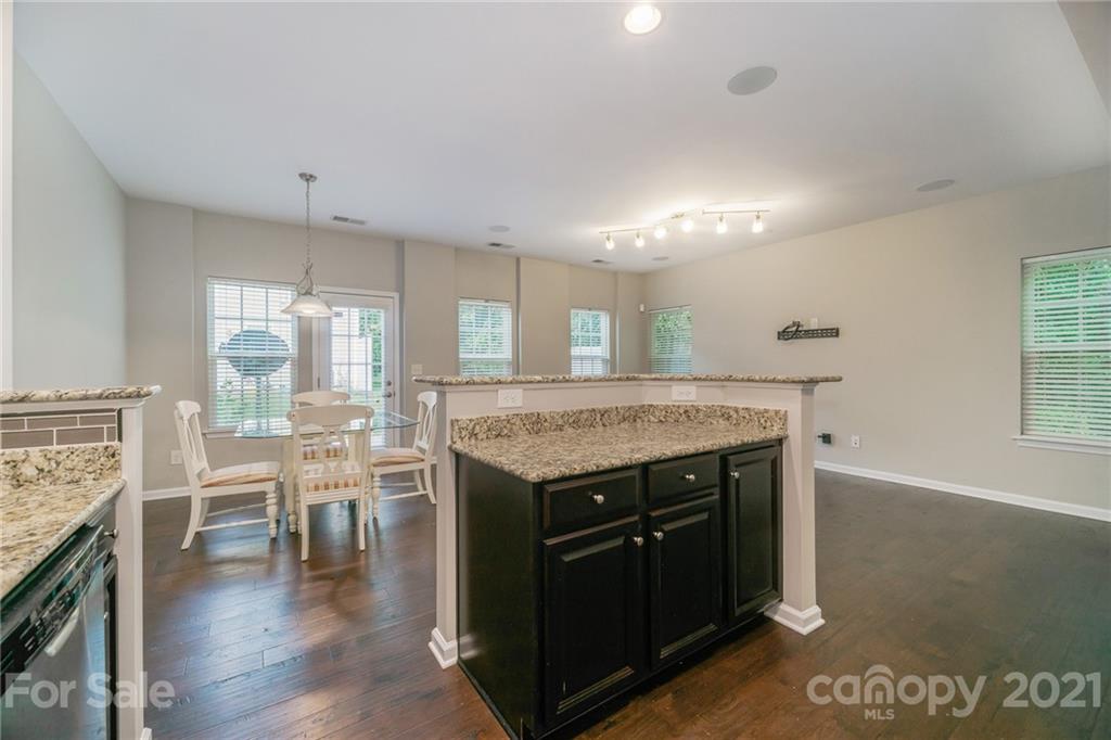 7304 Copper Beech Trace, Unit 13 Charlotte, NC 28273 - Photo 5 of 25 a kitchen with a stove and a wooden floor