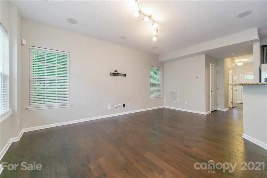 7304 Copper Beech Trace, Unit 13 Charlotte, NC 28273 - Photo 9 of 25 an empty room with wooden floor and windows
