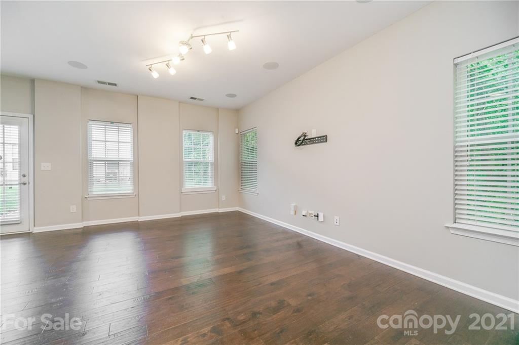 7304 Copper Beech Trace, Unit 13 Charlotte, NC 28273 - Photo 10 of 25 an empty room with wooden floor and windows