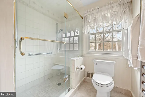 a bathroom with a granite countertop toilet a sink and shower